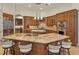 Gourmet kitchen featuring granite countertops, custom cabinetry, and a large island at 6130 Blakeford Dr, Windermere, FL 34786