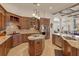 Spacious kitchen with granite countertops, custom wood cabinetry, and stainless steel appliances at 6130 Blakeford Dr, Windermere, FL 34786