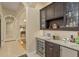 Home bar with granite countertop & wine cooler at 6130 Blakeford Dr, Windermere, FL 34786