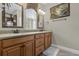 Double vanity bathroom with large mirrors and a walk-in shower at 637 Pavia Loop, Lake Mary, FL 32746