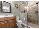 Bathroom featuring glass enclosed shower, toilet, and vanity with mirror at 637 Pavia Loop, Lake Mary, FL 32746