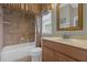 Well-lit bathroom showcasing a bathtub, shower with curtain, vanity, toilet and sink with gold mirror at 637 Pavia Loop, Lake Mary, FL 32746