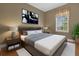 Comfortable bedroom featuring a wood bed frame, nightstands, and large window with natural light at 637 Pavia Loop, Lake Mary, FL 32746