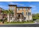 Attractive tan townhome with a Spanish-style tiled roof, landscaping, and walkway at 637 Pavia Loop, Lake Mary, FL 32746