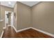 Long hallway with wood flooring and neutral walls at 637 Pavia Loop, Lake Mary, FL 32746