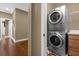 A stacked washer and dryer set in the laundry room and access to the hallway at 637 Pavia Loop, Lake Mary, FL 32746