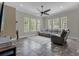 Spacious living room featuring a large sectional sofa and tile flooring at 637 Pavia Loop, Lake Mary, FL 32746