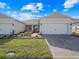Charming one-story home featuring a manicured lawn, brick driveway, and inviting entrance at 2542 Cliff Way, St Cloud, FL 34771