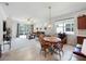 Open-concept living area featuring a dining table, plush seating, and natural light at 2542 Cliff Way, St Cloud, FL 34771