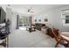 Comfortable living room with neutral decor, entertainment center, and glass sliding doors at 2542 Cliff Way, St Cloud, FL 34771