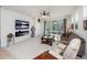 Inviting living room featuring neutral decor, plush seating, and access to the outdoor patio at 2542 Cliff Way, St Cloud, FL 34771