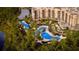 Aerial view of resort showing pools, landscaping, and building complex by the lake at 14501 Grove Resort Ave # 3109, Winter Garden, FL 34787
