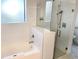 This bright bathroom features a glass-enclosed shower, tiled walls, and a bathtub at 14501 Grove Resort Ave # 3109, Winter Garden, FL 34787