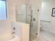 This bathroom features a glass-enclosed shower, tile flooring, grab bar, and a bathtub with marble tiling at 14501 Grove Resort Ave # 3109, Winter Garden, FL 34787