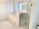 Modern bathroom features a glass-enclosed shower, bathtub, and tile flooring for a relaxing and clean aesthetic at 14501 Grove Resort Ave # 3109, Winter Garden, FL 34787