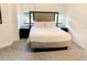 Comfortable bedroom with a well-made bed, side tables, and lamps near a window at 14501 Grove Resort Ave # 3109, Winter Garden, FL 34787