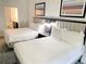 Bright bedroom featuring two beds, modern lamps, and artwork for a comfortable and stylish stay at 14501 Grove Resort Ave # 3109, Winter Garden, FL 34787