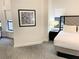 Cozy bedroom with patterned carpet and large picture window at 14501 Grove Resort Ave # 3109, Winter Garden, FL 34787