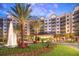 Beautiful building exterior with fountain, palm trees, blue sky, and well manicured landscaping at 14501 Grove Resort Ave # 3109, Winter Garden, FL 34787