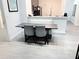 Modern dining room with a view of a kitchen area with new stainless steel appliances at 14501 Grove Resort Ave # 3109, Winter Garden, FL 34787