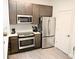 Modern kitchen featuring stainless steel appliances, wood floors, and white countertops at 14501 Grove Resort Ave # 3109, Winter Garden, FL 34787
