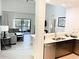 Modern living room next to kitchen area with stainless steel appliances at 14501 Grove Resort Ave # 3109, Winter Garden, FL 34787
