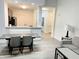 Bright living room with dining area and kitchen view, featuring modern gray and white design at 14501 Grove Resort Ave # 3109, Winter Garden, FL 34787
