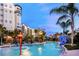 Resort pool area with water features and blue slide, surrounded by palm trees at 14501 Grove Resort Ave # 3109, Winter Garden, FL 34787