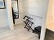Bright walk-in closet featuring wire shelving, a luggage rack, mirror, ironing board, and a small personal safe at 14501 Grove Resort Ave # 3109, Winter Garden, FL 34787