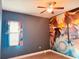 Bedroom with Naruto wall art, window, and ceiling fan at 32702 View Haven Ln, Sorrento, FL 32776