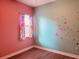 Bedroom with pink and teal walls, window, and butterfly decor at 32702 View Haven Ln, Sorrento, FL 32776