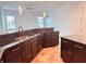Modern kitchen featuring dark wood cabinets and granite countertops at 32702 View Haven Ln, Sorrento, FL 32776