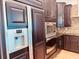 Dark wood kitchen cabinets with stainless steel appliances at 32702 View Haven Ln, Sorrento, FL 32776