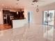 Spacious kitchen with island, dark cabinetry, and marble flooring at 32702 View Haven Ln, Sorrento, FL 32776