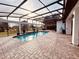 Inviting pool area with covered patio, pavers, and lush landscaping at 32702 View Haven Ln, Sorrento, FL 32776