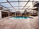 Inviting screened pool and patio area with brick pavers at 32702 View Haven Ln, Sorrento, FL 32776