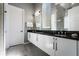 Sleek bathroom featuring double sinks, white cabinets, and a glass enclosed shower for a spa-like experience at 1758 Oak Blossom Dr, Davenport, FL 33837