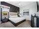 Well-lit bedroom with a stylish paneled accent wall, comfortable bed, and contemporary decor at 1758 Oak Blossom Dr, Davenport, FL 33837