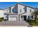 Charming two-story home boasts an attached garage, stone accents, and a well-manicured front yard at 1758 Oak Blossom Dr, Davenport, FL 33837