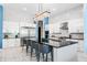 Modern kitchen with stainless steel appliances, center island with seating and designer light fixture at 1758 Oak Blossom Dr, Davenport, FL 33837