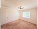Clean and bright bedroom featuring plush carpet, a ceiling fan, and natural light from a large window at 4904 Blanche Ct, Saint Cloud, FL 34772