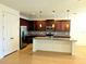 Bright kitchen featuring a central island, stainless steel appliances, granite countertops, and modern pendant lighting at 4904 Blanche Ct, Saint Cloud, FL 34772