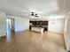 Open-concept living area featuring tiled floors that transition into a modern kitchen with stainless steel appliances at 4904 Blanche Ct, Saint Cloud, FL 34772