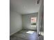 Well-lit bedroom with wood-look floors and window at 1844 Coriander Dr, Poinciana, FL 34759