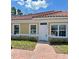 Front entrance with brick walkway and landscaping at 1844 Coriander Dr, Poinciana, FL 34759