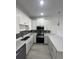 Modern kitchen with white cabinets and stainless steel appliances at 1844 Coriander Dr, Poinciana, FL 34759