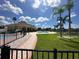 Community pool area with a clubhouse and landscaping at 1844 Coriander Dr, Poinciana, FL 34759