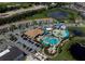 Aerial view showing community pool, water park, and surrounding buildings at 224 Macaulay'S Cv, Haines City, FL 33844