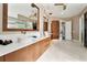 Bathroom with double vanity, modern lighting, and hardwood floors at 8625 Bay Hill Blvd, Orlando, FL 32819