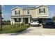 Two-story house with a two-car garage and landscaped lawn at 4499 Magnolia Ridge Ct, Kissimmee, FL 34746